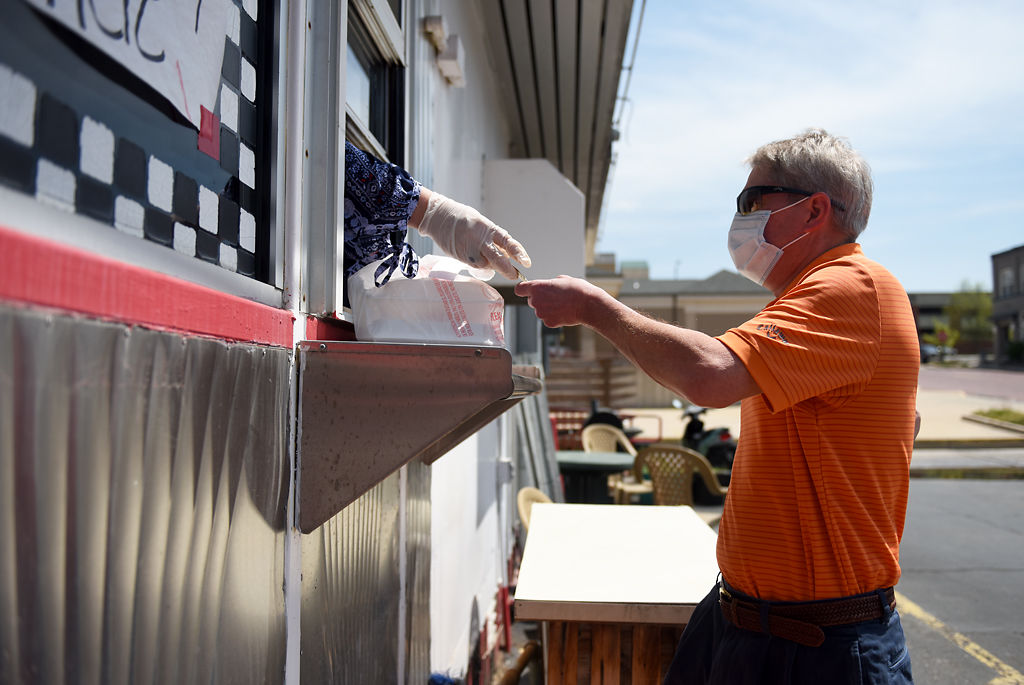 Doug Brown pays for his food at the Broadway Diner pickup window